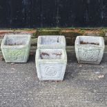 A set of four reconstituted stone planters,