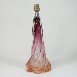 An early 20th century amber graduated coloured red glass table lamp base, of twisted form,
