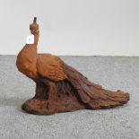 A rusted metal garden model of a peacock,