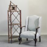 A 1920's blue upholstered wing back armchair, together with a bamboo corner whatnot,