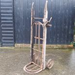 An early 20th century wooden and iron grain barrow,