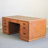 A mid 20th century light oak pedestal desk,