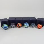 A collection of six various small glass paperweights,