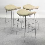 A set of three chrome bar stools,