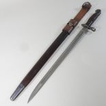 An early 20th century 1913 pattern Remington bayonet, with a wooden handle, in a leather scabbard,