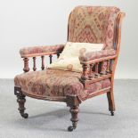 A Victorian oak and red patterned upholstered armchair