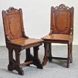 A pair of Victorian gothic style oak hall chairs