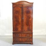 A reproduction mahogany wardrobe, by Bradley Furniture,