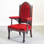 A Victorian gothic style red upholstered armchair