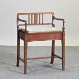 An Edwardian mahogany and inlaid piano stool,