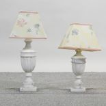 A pair of turned white marble table lamps and shades,