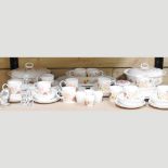 Two shelves of china to include a Wedgwood Summer Bouquet part dinner and tea service,
