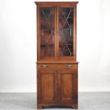 An Edwardian walnut astragal glazed cabinet bookcase, of narrow proportions,