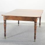 A Regency mahogany pull-out extending dining table, on ring turned legs, with an additional leaf,