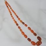 A large amber coloured bead necklace,