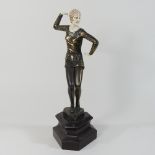 An Art Deco style metal figure of a young girl, on a marbled base,