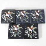 A collection of five black marble and inlaid tiles,