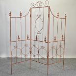 A metal three-fold garden screen,