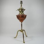 An early 20th century Arts and Crafts brass and copper oil lamp, in the manner of WAS Benson,