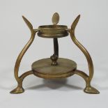 An Arts and Crafts brass stand, on three feet, by WAS Benson, stamped to base,