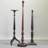 An early 20th century mahogany torchere, together with two standard lamps,