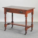 A Victorian walnut writing table, with an inset leather top, on turned legs,