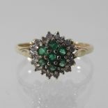 A 9 carat gold emerald and diamond cluster ring,