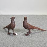 A pair of rusted metal garden models of pheasants,