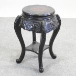 A 20th century oriental carved and ebonised jardiniere stand,