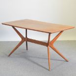 A 1960's G Plan teak Helicopter design dining table, on a shaped base,
