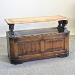 A mid 20th century oak monk's bench, with linen fold decoration,