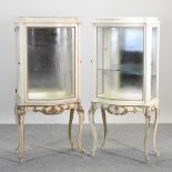 A pair of cream painted vitrines, bearing a label for Milano Furniture Co, Chicago,