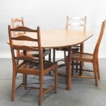 An Ercol light elm extending dining table, 166 x 100cm closed,