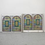 A near pair of stained glass window panels,