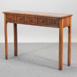 A good quality reproduction oak five drawer side table,