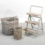 A three tier display stand, together with a set of five circular graduated wicker baskets,
