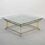 A brass coffee table, with a glass top,