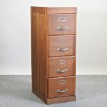 A mid 20th century light oak filing cabinet, containing four drawers,