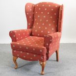 A red upholstered wing back chair