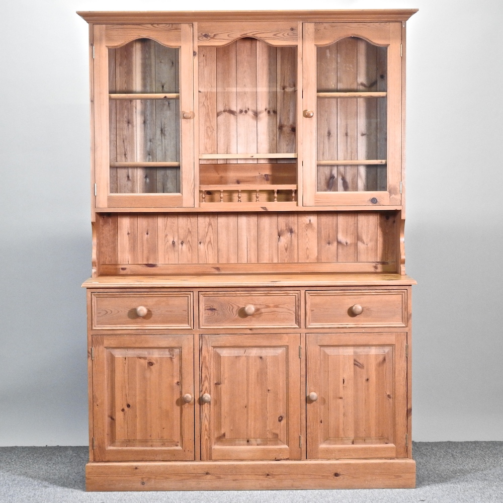 A modern pine dresser, with a glazed upper section,