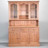 A modern pine dresser, with a glazed upper section,