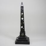A black and inlaid marble obelisk,
