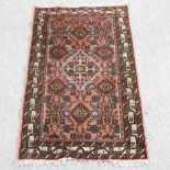 A Turkish woollen rug, with a central medallion,