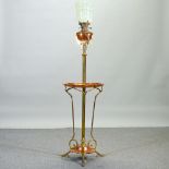 An ornate Arts and Crafts copper and brass telescopic standard lamp, in the manner of WAS Benson,