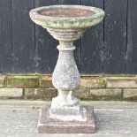 A reconstituted stone bird bath,