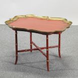 A red and gilt painted coffee table,