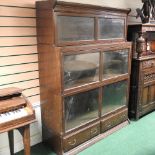 An early 20th century oak Globe Wernicke style bookcase, containing three tiers, with drawers below,