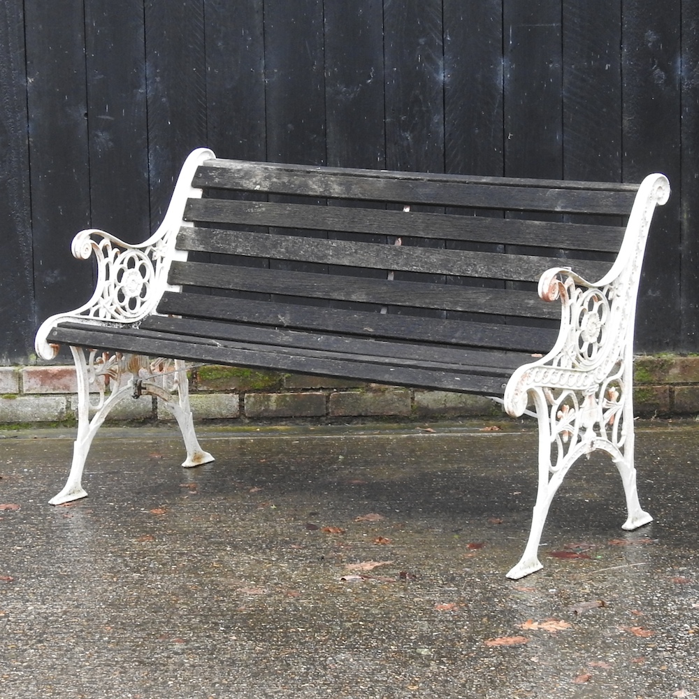 A slatted garden bench, with iron ends,