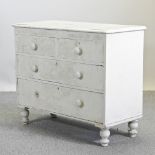 A white painted chest of drawers,