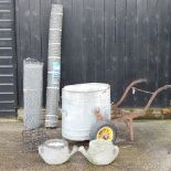 A galvanised water butt, on a frame, together with two rolls of galvanised chicken wire,